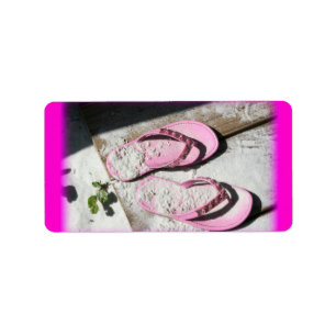 Pink sandy flip flop sandals on Florida beach Label