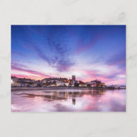 Pink sunset reflections over Cromer town at dusk