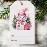 Pink Whimsical Holiday Snowman Christmas Gift Tags<br><div class="desc">Add a touch of whimsy to your holiday gifts with these Christmas gift tags showcasing a charming watercolor snowman in pretty pink tones, accompanied by wrapped presents and a snowy pine trees. Easily personalise them by writing in the names in the to and from sections. Simply add these festive gift...</div>