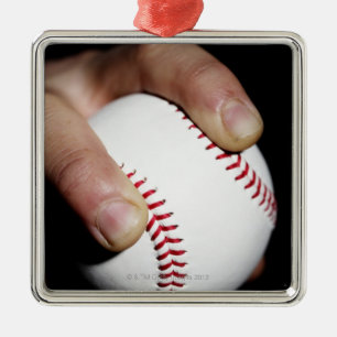 Pitchers hand gripping a baseball metal tree decoration