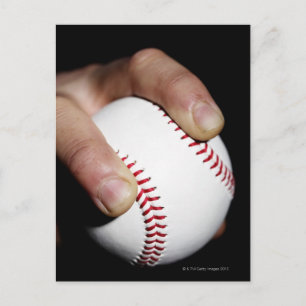 Pitchers hand gripping a baseball postcard