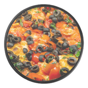 Pizza with black olives hockey puck