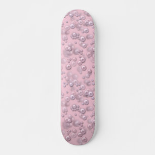 Placers of white-pink pearls on pink velvet skateboard