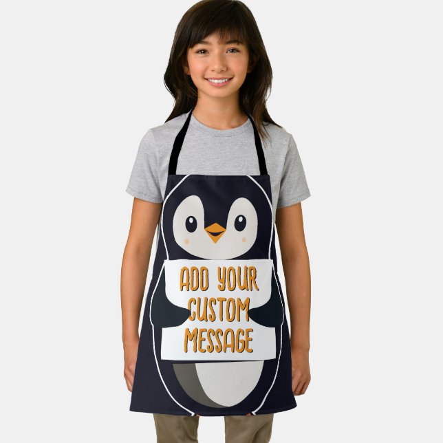 Playful penguin with a sign for your message apron (Insitu)