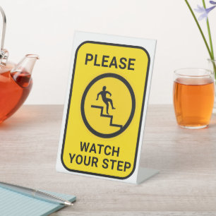 PLEASE WATCH YOUR STEP PEDESTAL SIGN