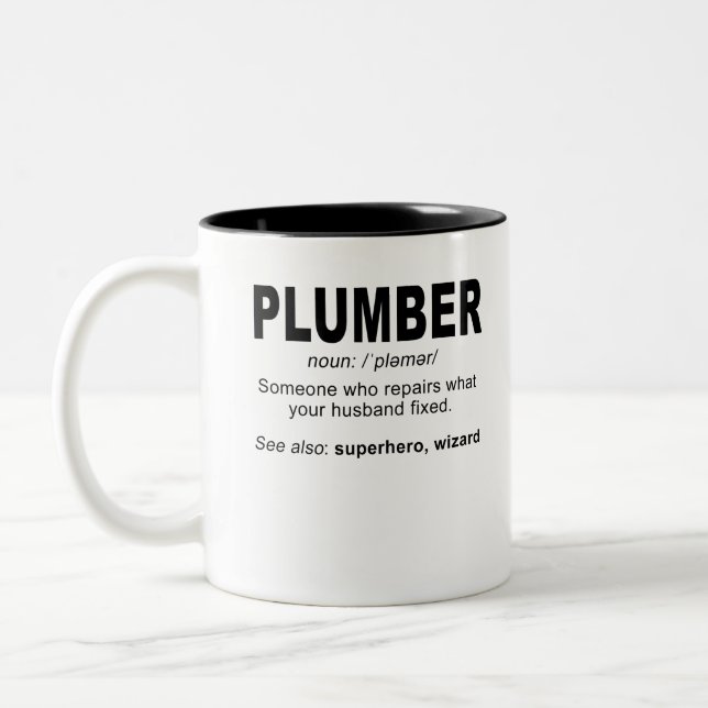 Plumber noun: /pləmər/ Someone who repairs what Two-Tone Coffee Mug (Left)