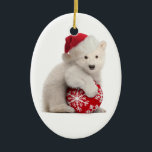 Polar Bear Cub Christmas Ornament<br><div class="desc">This Christmas ornament features a photo of a cute polar bear cub wearing a Santa hat and holding a red ball decorated with snowflakes. Makes a great gift for animal lovers!</div>