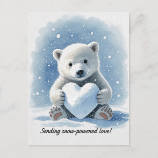 Polar bear in the snow with heart shaped snowball postcard