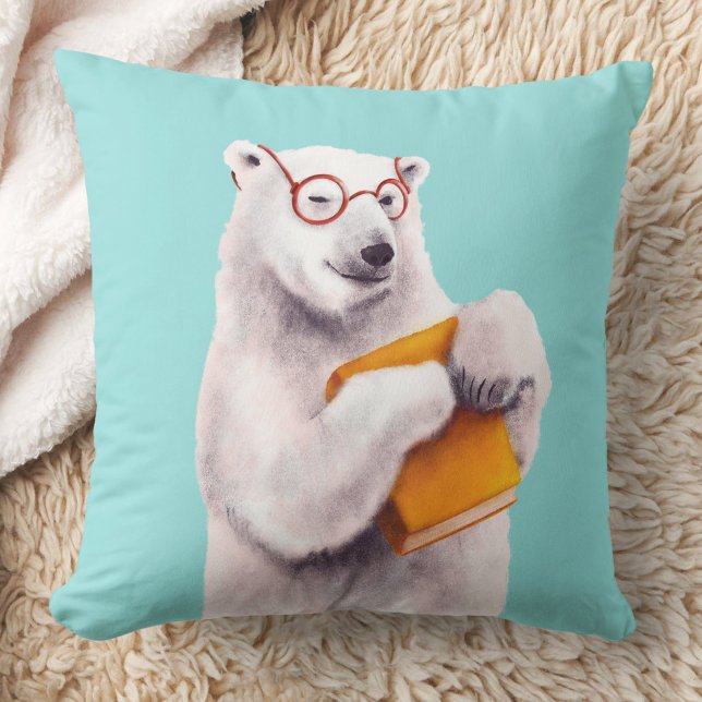 Polar Bear Reading Art – Book Lover Cushion (blue pillow with a polar bear with eyeglasses holding a yellow book)