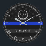 Police Styled American Flag Badge and Name Large Clock<br><div class="desc">A wall clock featuring a thin blue line American flag symbolic of law-enforcement.  Roman numerals and a spot for yours or your gift recipient's badge number and last name.</div>