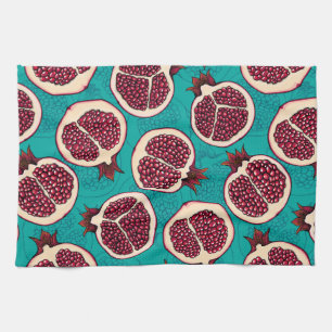 Pomegranate slices on turquoise tea towel