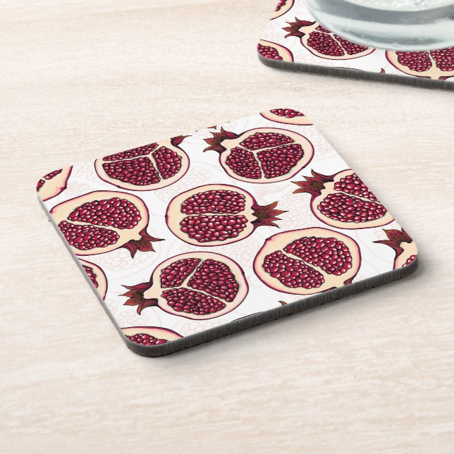 Pomegranate slices on white coaster (Left Side)