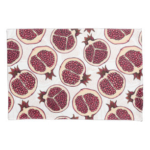 Pomegranate slices on white pillowcase