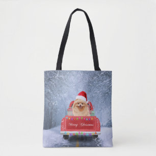 Pomeranian Dog in Snow sitting in Christmas Truck Tote Bag