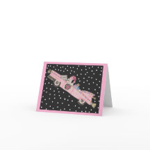 Poodle at Christmas in a pink convertible