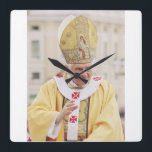 Pope Benedict XVI The Teacher of Truth Square Wall Clock<br><div class="desc">Elevate your space with the serene and scholarly presence of Pope Benedict XVI. This high-fidelity reproduction portrays the Pope in a moment of prayerful reflection, embodying the "humble worker in the vineyard of the Lord." The composition highlights the dignity of the papacy and the personal warmth of Joseph Ratzinger, known...</div>