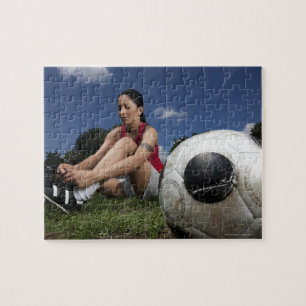 portrait of female football player tying her jigsaw puzzle