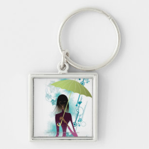 Portrait of young woman holding purse and umbrella key ring