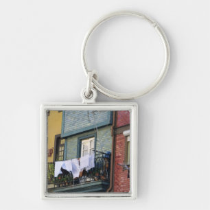 Portugal, Oporto (Porto). Woman hanging laundry Key Ring