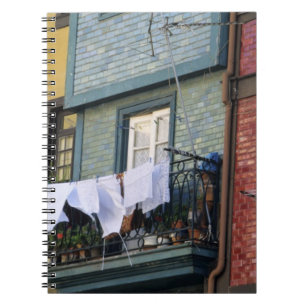 Portugal, Oporto (Porto). Woman hanging laundry Notebook