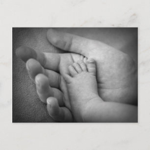 Postcard of baby's foot in mothers hand.