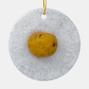 Potato macro as background with salt ceramic tree decoration