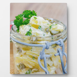Potato salad in a jar on wooden plaque