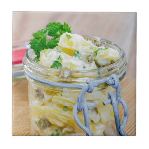 Potato salad in a jar on wooden tile