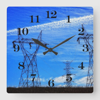 Power lines in blue sky square wall clock