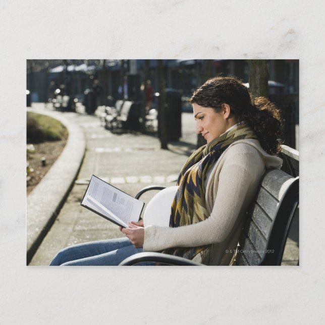 Pregnant Middle Eastern woman reading on park Postcard (Front)