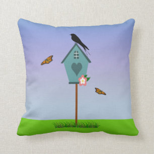 Pretty Bird Silhouette on top a Blue Birdhouse Cushion