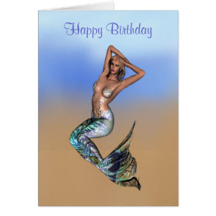 Pretty blonde mermaid laying on the beach