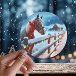 Pretty Brown Horse with Bow Christmas   Classic Round Sticker<br><div class="desc">Christmas stickers. A pretty brown horse with a red bow on his neck standing behind an old rustic wood fence with a snowy background and vintage old red barn.</div>