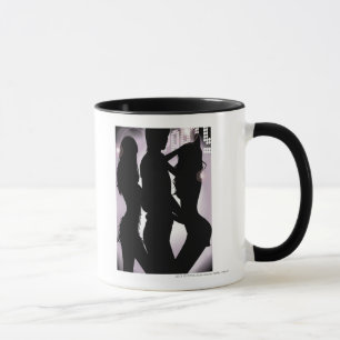 Profile of a man dancing with women in a nightclub mug
