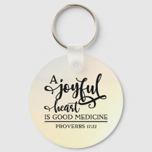 Proverbs 17:22 A cheerful heart is good medicine Key Ring