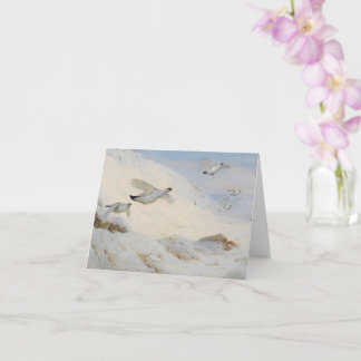 Ptarmigan in winter plumage,flying across the snow card