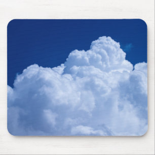 Puffy clouds in blue sky mouse mat