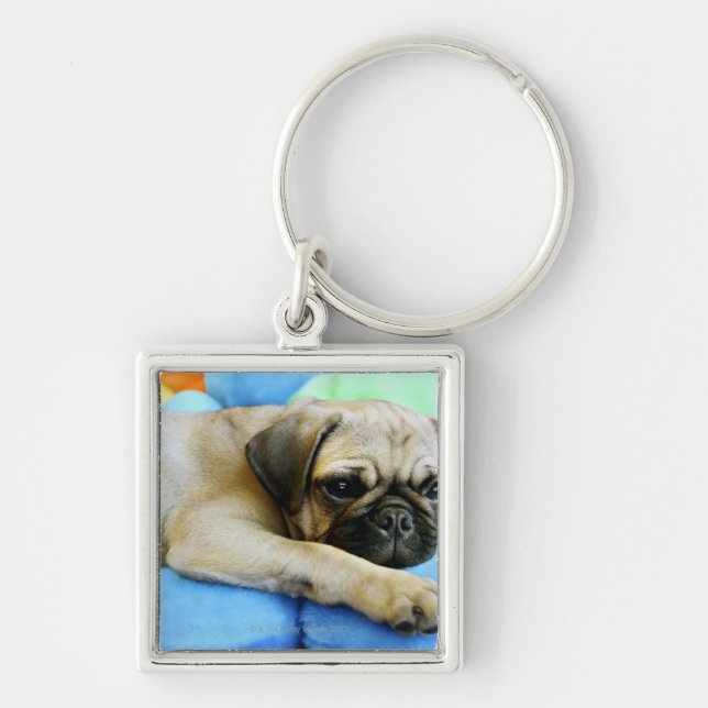 Pug laying on pillows key ring (Front)