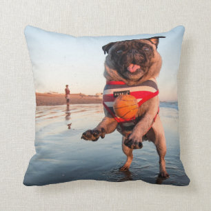 Pug Playing Ball on Beach Cushion