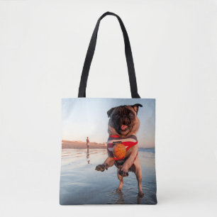 Pug Playing Ball on Beach Tote Bag