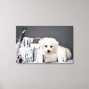 Puppy sitting amongst paint tins canvas print