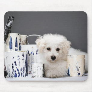 Puppy sitting amongst paint tins mouse mat