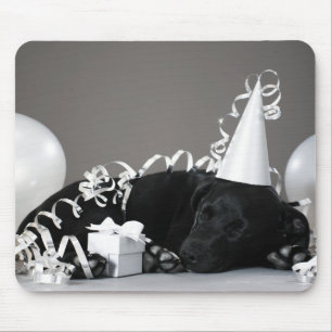Puppy sleeping in party decorations mouse mat