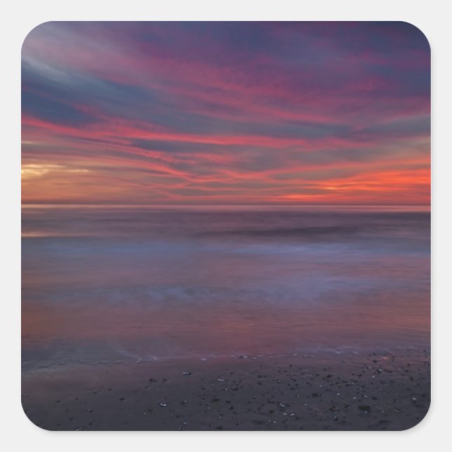 Purple-coloured sunrise on ocean shore square sticker (Front)