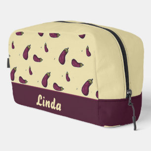 Purple eggplants on cream colour dopp kit