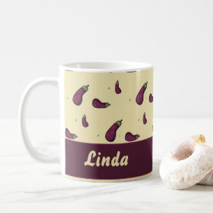 Purple eggplants on yellow coffee mug