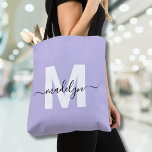 Purple Elegant Script Name Monogram Tote Bag<br><div class="desc">Personalised Girly Light Purple and White Trendy Modern Script Name Monogram Tote Bag. Add a soft and feminine touch to your everyday style with this chic and playful tote bag. Featuring a light purple background and a bold white initial (with no shimmer or foil), paired with a sleek black script...</div>