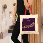 Purple gold music notes name monogram tote bag<br><div class="desc">Simple and elegant for a music lover! Purple background with faux gold music notes. Template for your name,  golden hand lettered style script.</div>