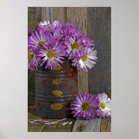 purple mum flowers in rusty tin can