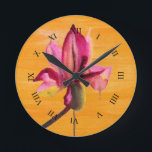 Purple Orchid watercolour orange pop art flower Round Clock<br><div class="desc">From original watercolour painting by Sacha Grossel of a purple watercolour flower design on a bright orange pop art vividly colored painted art background. This vibrant design was inspired by tropical floral climates and is a botanical meets pop art style.</div>